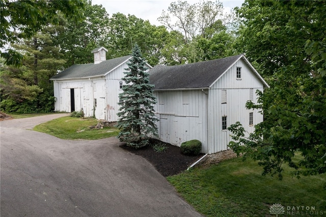 5894 Hamilton Lebanon Rd, Monroe, OH 45044 - view of outbuilding with asphalt driveway and view of wooded area