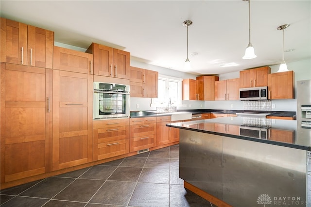 5894 Hamilton Lebanon Rd, Monroe, OH 45044 - kitchen featuring stainless steel oven, dark countertops, pendant lighting, a sink, and a kitchen island
