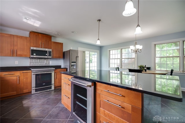 5894 Hamilton Lebanon Rd, Monroe, OH 45044 - kitchen with stainless steel appliances, wine cooler, dark countertops, and brown cabinets