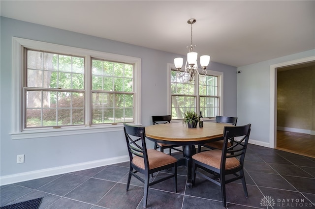 5894 Hamilton Lebanon Rd, Monroe, OH 45044 - dining area featuring a chandelier, healthy amount of natural light, dark tile patterned flooring, and baseboards