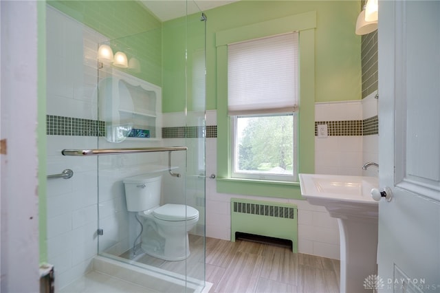 5894 Hamilton Lebanon Rd, Monroe, OH 45044 - bathroom featuring radiator, tile walls, and toilet