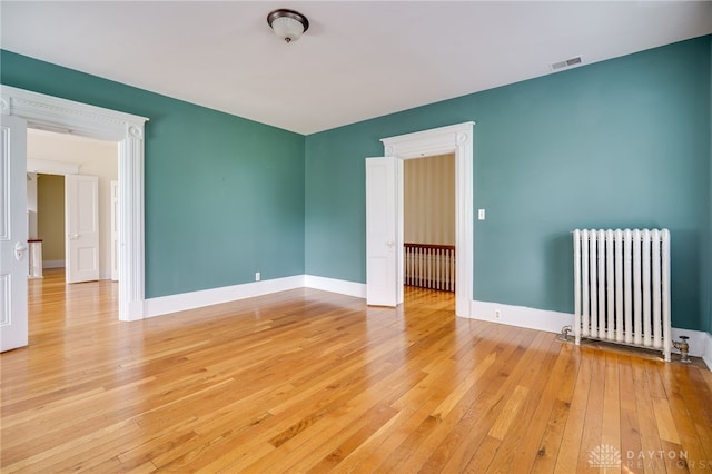 5894 Hamilton Lebanon Rd, Monroe, OH 45044 - unfurnished room with radiator, light wood-style floors, and baseboards