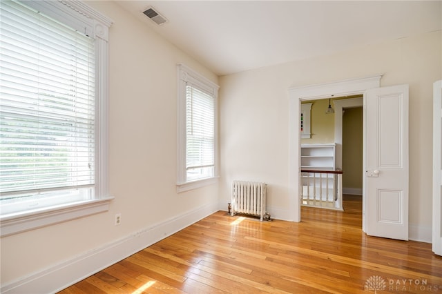 5894 Hamilton Lebanon Rd, Monroe, OH 45044 - empty room featuring radiator, light wood finished floors, and baseboards