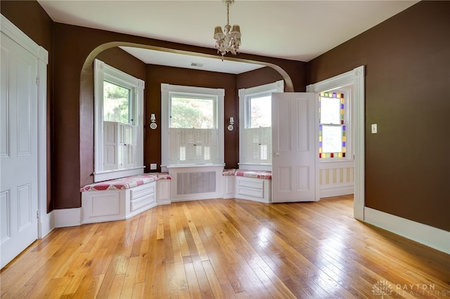 5894 Hamilton Lebanon Rd, Monroe, OH 45044 - entryway featuring a chandelier, light wood-style floors, arched walkways, and radiator