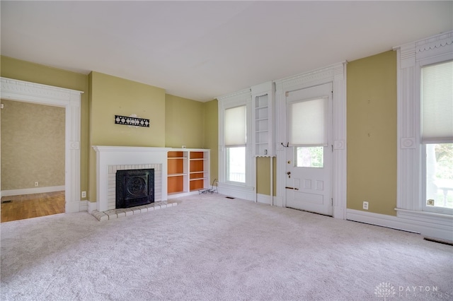 5894 Hamilton Lebanon Rd, Monroe, OH 45044 - unfurnished living room with carpet, plenty of natural light, a brick fireplace, and baseboards