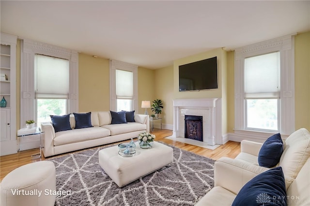 5894 Hamilton Lebanon Rd, Monroe, OH 45044 - living area with a fireplace with flush hearth and wood finished floors