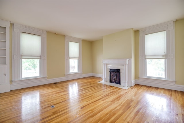 5894 Hamilton Lebanon Rd, Monroe, OH 45044 - unfurnished living room with wood finished floors, a fireplace, and baseboards