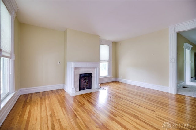 5894 Hamilton Lebanon Rd, Monroe, OH 45044 - unfurnished living room featuring light wood-style flooring, a fireplace, and baseboards
