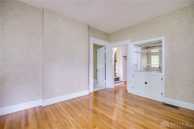 5894 Hamilton Lebanon Rd, Monroe, OH 45044 - unfurnished room with light wood finished floors, stairway, and baseboards