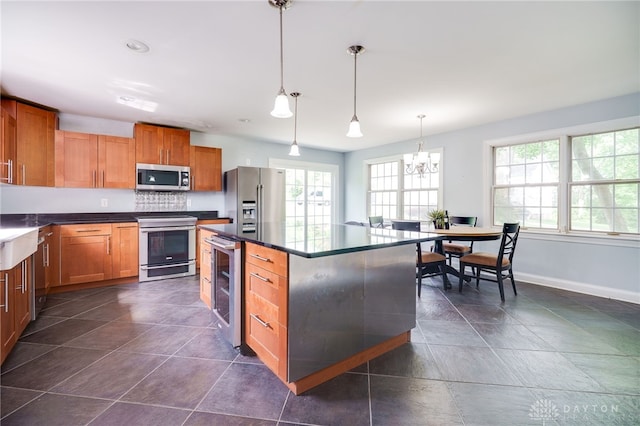 5894 Hamilton Lebanon Rd, Monroe, OH 45044 - kitchen with stainless steel appliances, healthy amount of natural light, beverage cooler, and baseboards