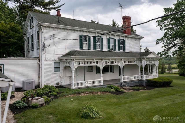 5894 Hamilton Lebanon Rd, Monroe, OH 45044 - view of front of home with a porch, a chimney, a front lawn, and central AC