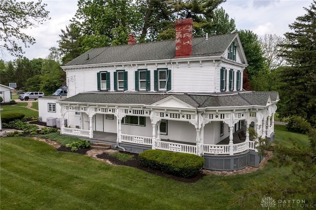5894 Hamilton Lebanon Rd, Monroe, OH 45044 - rear view of house featuring a porch, a yard, a chimney, and a shingled roof