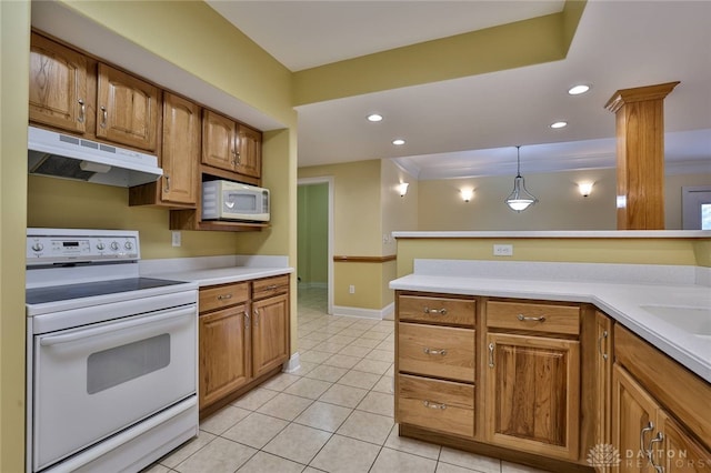 3085 State Route 122, Springboro, OH 45005 - kitchen featuring white appliances, under cabinet range hood, light countertops, light tile patterned floors, and brown cabinets