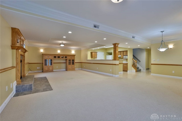 3085 State Route 122, Springboro, OH 45005 - unfurnished living room featuring ornamental molding, light colored carpet, stairs, baseboards, and decorative columns