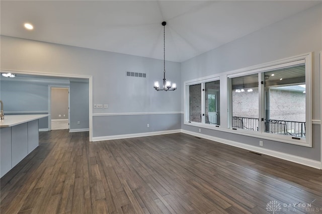 3085 State Route 122, Springboro, OH 45005 - unfurnished dining area featuring a chandelier, dark wood finished floors, and baseboards