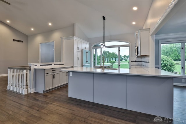 3085 State Route 122, Springboro, OH 45005 - kitchen featuring vaulted ceiling, a peninsula, high end refrigerator, light countertops, and backsplash