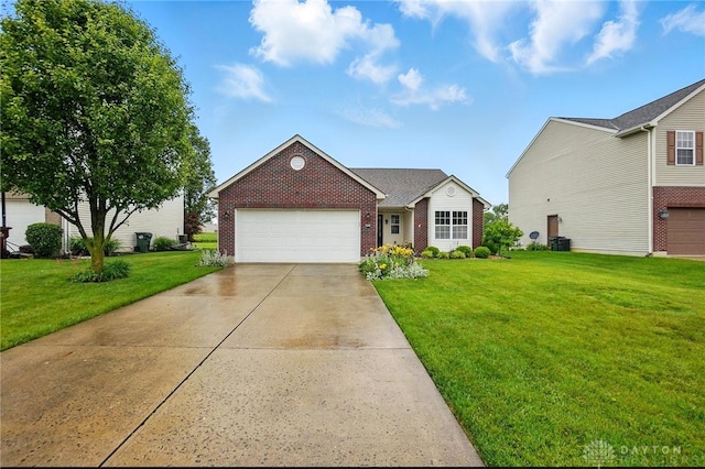 1248 Kern Dr, Germantown, OH 45327 - view of front of property featuring brick siding, a front yard, driveway, and an attached garage