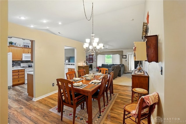 1248 Kern Dr, Germantown, OH 45327 - dining area with a chandelier, light wood finished floors, and lofted ceiling