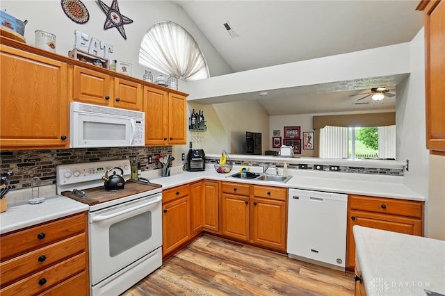 1248 Kern Dr, Germantown, OH 45327 - kitchen featuring white appliances, vaulted ceiling, a sink, tasteful backsplash, and light wood-type flooring
