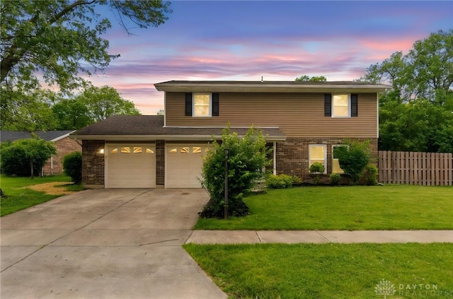 4513 Silver Oak St, Dayton, OH 45424 - traditional home with driveway, a garage, and brick siding