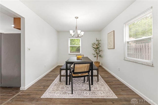 4513 Silver Oak St, Dayton, OH 45424 - dining area with dark wood finished floors, a chandelier, and baseboards