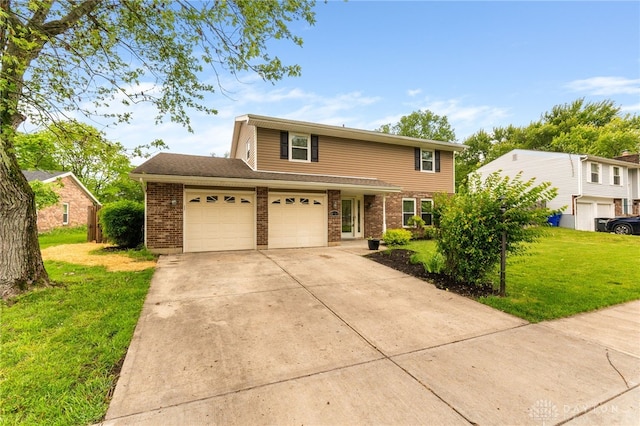 4513 Silver Oak St, Dayton, OH 45424 - traditional-style home with brick siding, a front lawn, driveway, and a shingled roof