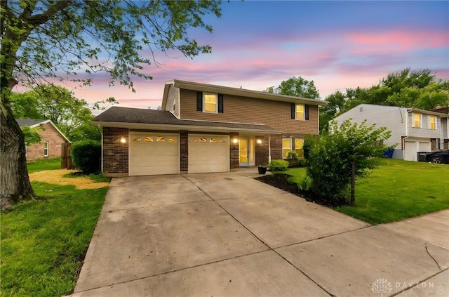 4513 Silver Oak St, Dayton, OH 45424 - traditional home featuring a yard, concrete driveway, brick siding, and an attached garage
