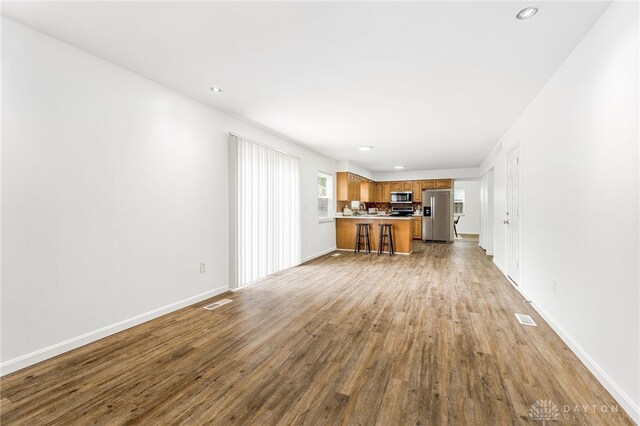 4513 Silver Oak St, Dayton, OH 45424 - unfurnished living room featuring wood finished floors, recessed lighting, and baseboards