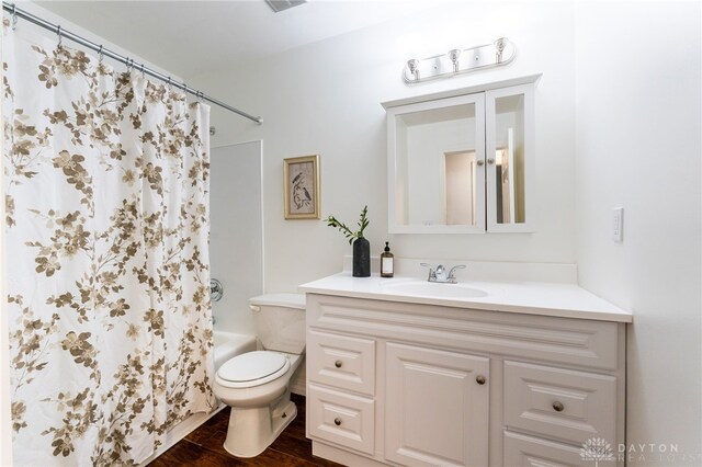 4513 Silver Oak St, Dayton, OH 45424 - bathroom featuring vanity, wood finished floors, toilet, and shower / bathtub combination with curtain