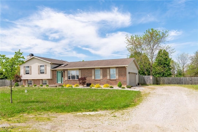 9673 Dayton Greenville Pike, Brookville, OH 45309 - split level home with brick siding, driveway, a garage, and a chimney