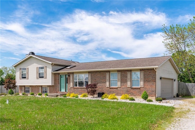 9673 Dayton Greenville Pike, Brookville, OH 45309 - split level home featuring brick siding, an attached garage, driveway, and a chimney