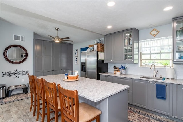 9673 Dayton Greenville Pike, Brookville, OH 45309 - kitchen with gray cabinetry, stainless steel refrigerator with ice dispenser, a sink, backsplash, and recessed lighting