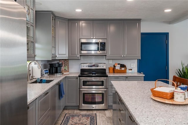 9673 Dayton Greenville Pike, Brookville, OH 45309 - kitchen with gray cabinets, appliances with stainless steel finishes, a sink, glass insert cabinets, and recessed lighting