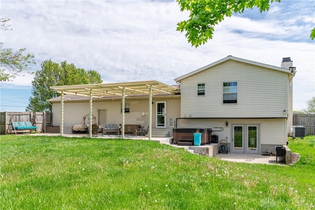 9673 Dayton Greenville Pike, Brookville, OH 45309 - back of property featuring a patio area, a hot tub, cooling unit, and a chimney