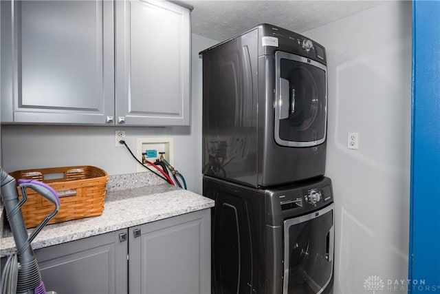9673 Dayton Greenville Pike, Brookville, OH 45309 - washroom featuring cabinet space and stacked washer / dryer