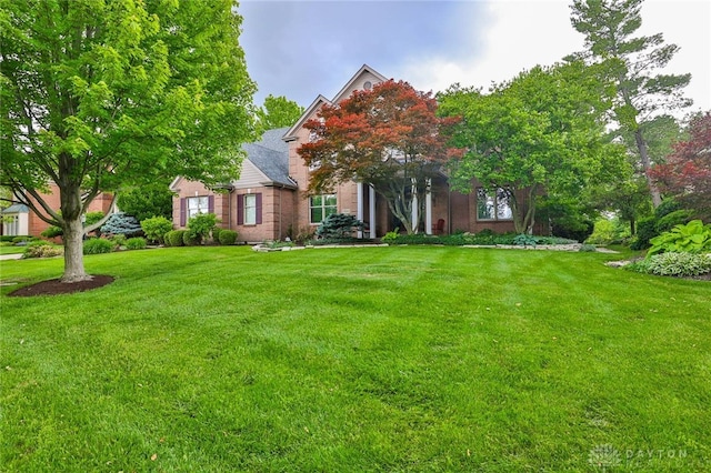 7299 Country Club Ln, West Chester, OH 45069 - view of property hidden behind natural elements featuring a front lawn and brick siding