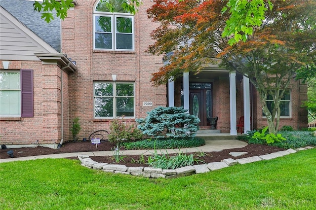 7299 Country Club Ln, West Chester, OH 45069 - view of exterior entry with a lawn and brick siding