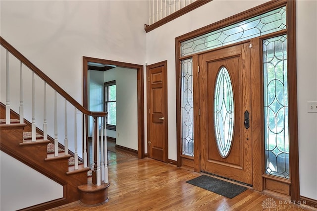 7299 Country Club Ln, West Chester, OH 45069 - foyer with light wood-style floors, stairs, baseboards, and a towering ceiling