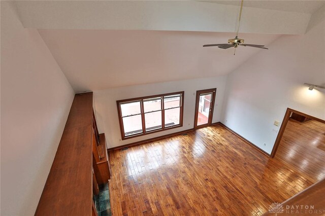 7299 Country Club Ln, West Chester, OH 45069 - unfurnished living room with wood-type flooring, baseboards, ceiling fan, and high vaulted ceiling