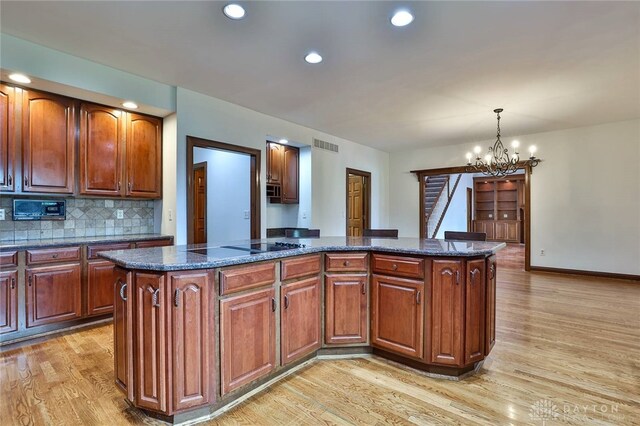7299 Country Club Ln, West Chester, OH 45069 - kitchen featuring light wood-type flooring, a chandelier, a center island, hanging light fixtures, and recessed lighting