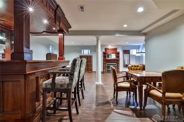 7299 Country Club Ln, West Chester, OH 45069 - dining room with decorative columns, wood finished floors, a fireplace, and recessed lighting