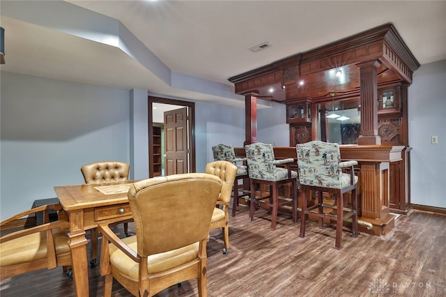 7299 Country Club Ln, West Chester, OH 45069 - dining room featuring a bar, wood finished floors, baseboards, and ornate columns