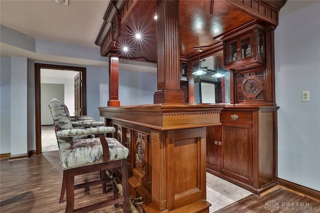 7299 Country Club Ln, West Chester, OH 45069 - bar with baseboards, dark wood-style floors, and ornate columns