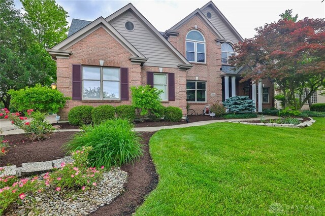 7299 Country Club Ln, West Chester, OH 45069 - traditional-style house featuring brick siding and a front yard