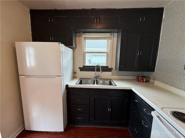 1805 Fauver Ave, Dayton, OH 45420 - kitchen with white appliances, a sink, dark wood finished floors, light countertops, and dark cabinets