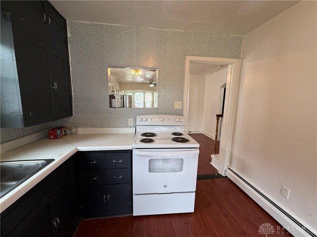 1805 Fauver Ave, Dayton, OH 45420 - kitchen featuring white electric range, a baseboard heating unit, dark cabinetry, dark wood-style floors, and a sink