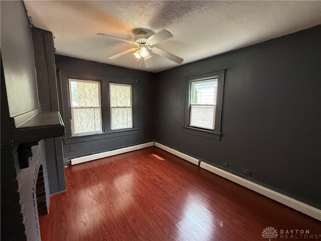 1805 Fauver Ave, Dayton, OH 45420 - empty room with wood finished floors, a baseboard heating unit, ceiling fan, baseboards, and a textured ceiling