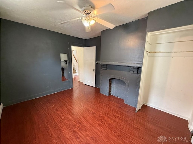 1805 Fauver Ave, Dayton, OH 45420 - unfurnished living room featuring a brick fireplace, a ceiling fan, wood finished floors, and baseboards