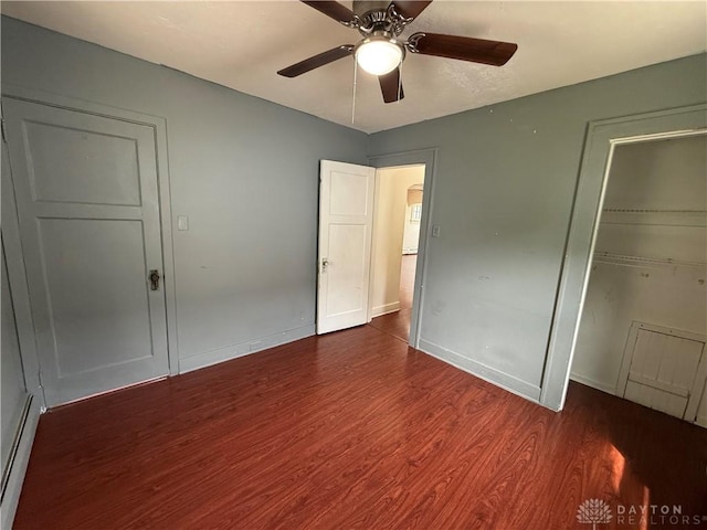1805 Fauver Ave, Dayton, OH 45420 - unfurnished bedroom with dark wood-style floors, baseboard heating, a closet, baseboards, and a ceiling fan