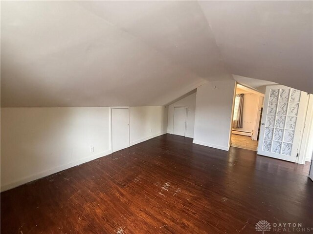 1805 Fauver Ave, Dayton, OH 45420 - bonus room featuring a baseboard heating unit, lofted ceiling, dark wood-type flooring, and baseboards